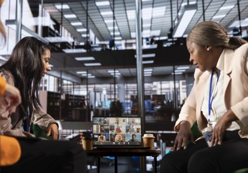 Diverse group of businesswomen participate in a remote conference call, showcasing leadership and cultural diversity for a successful business in an inclusive workspace. Setting tasks in a meeting.